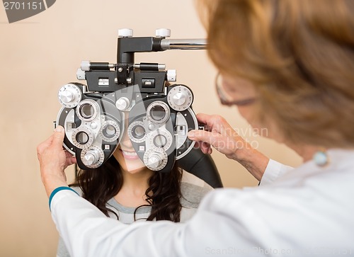 Image of Optometrist Adjusting Phoropter For Patient