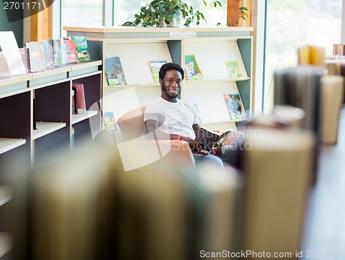Image of Student Reading Book In Library