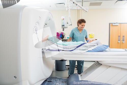 Image of Nurse Looking At Patient Undergoing CT Scan Test