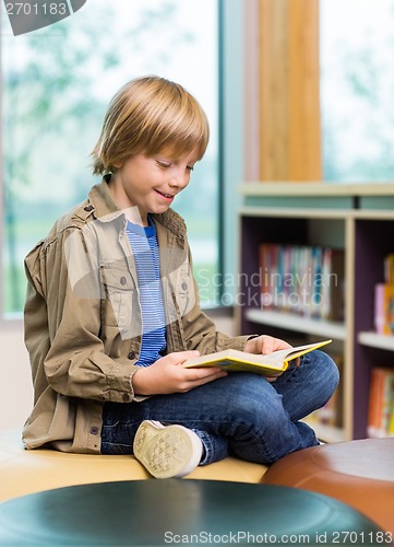 Image of Happy Boy Reading Book In Library