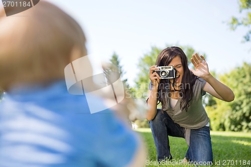 Image of Mother Photographing Son Through Camera