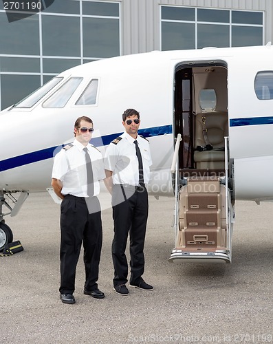 Image of Pilots Standing By Private Jet