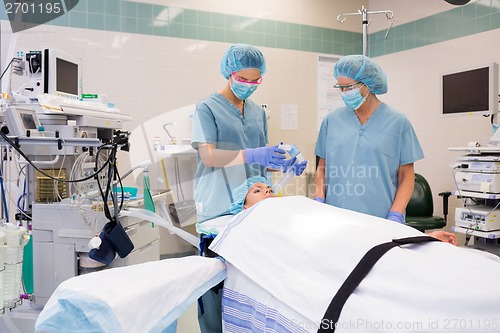 Image of Nurse Adjusting Oxygen Mask On Patient