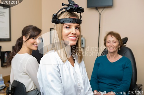 Image of Optometrists With Senior Patient In Store