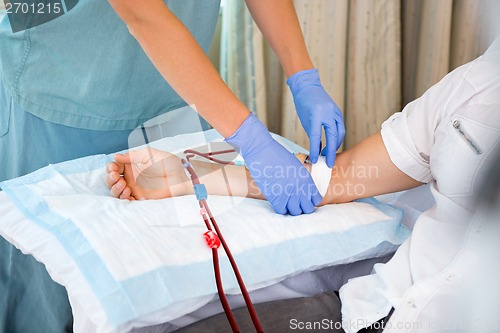 Image of Nurse Starting Dialysis on Patient