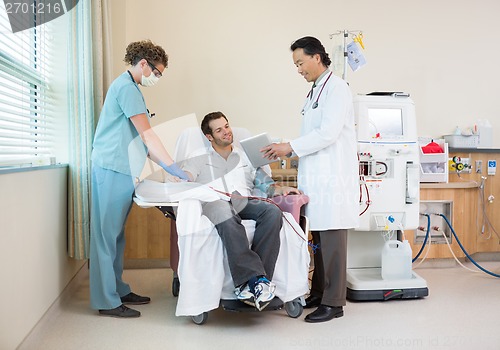 Image of Doctor Showing Digital Chart to Dialysis Patient