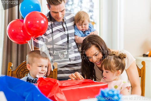 Image of Family Opening Birthday Present At Home