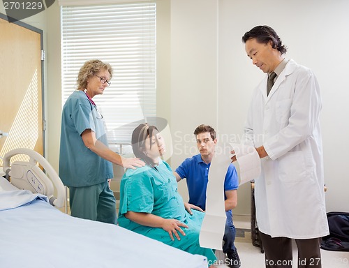 Image of Doctor Explaining Fetal Monitor Report To Pregnant Woman