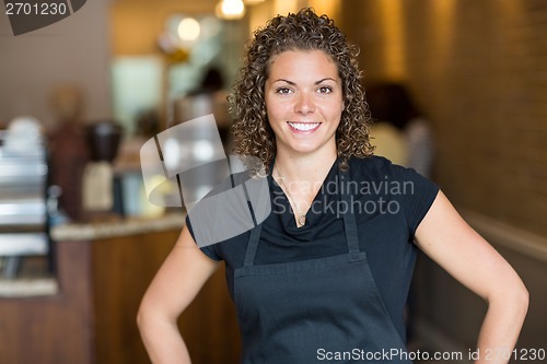 Image of Happy Waitress Standing In Cafe