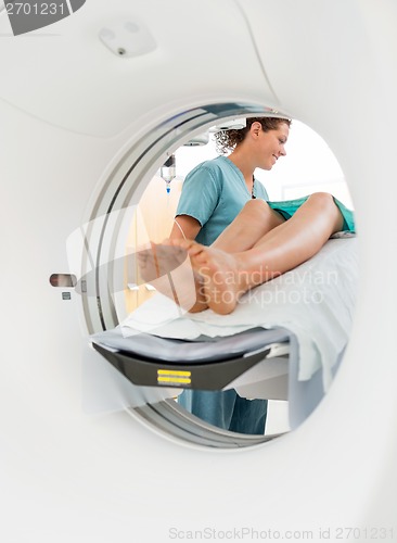 Image of Nurse Looking At Patient Undergoing CT Scan