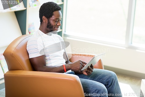 Image of Student Using Digital Tablet In Bookstore