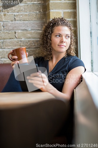 Image of Woman With Coffee Mug And Digital Tablet In Cafe