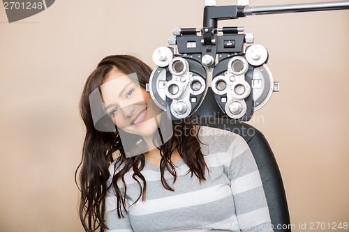 Image of Happy Woman Sitting Behind Phoropter