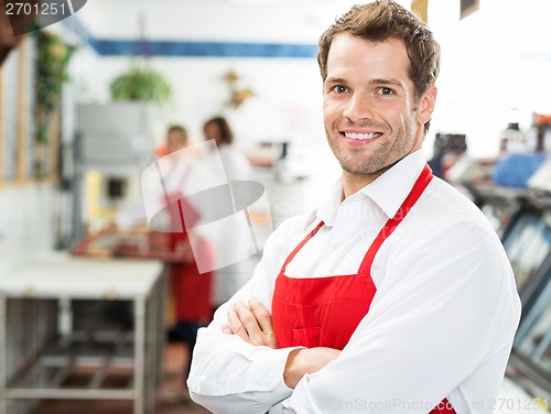 Image of Happy Butcher Standing Arms Crossed At Store