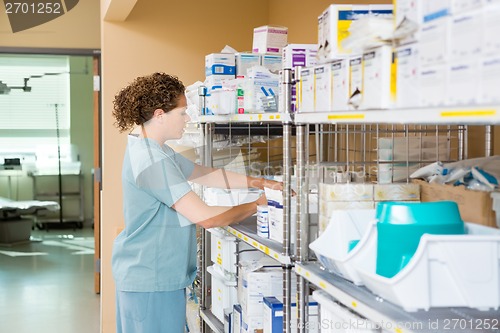 Image of Nurse Working In Storage Room Of Hospital