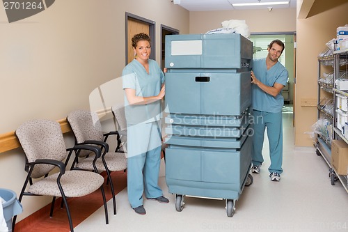 Image of Nurses Pushing Trolley In Hospital Hallway