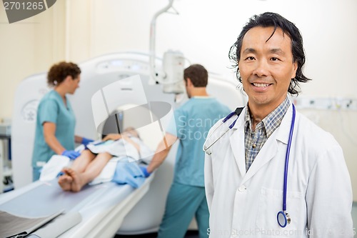 Image of Radiologist With Nurses Preparing Patient For CT Scan