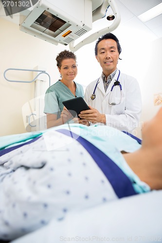 Image of Medical Team Looking At Patient On Xray Table