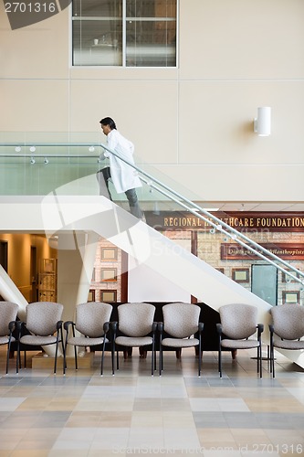 Image of Doctor Climbing Up Stairs In Hospital