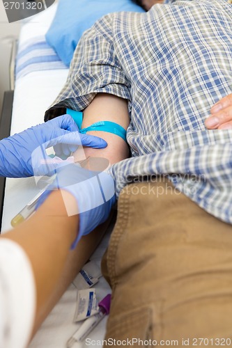 Image of Doctor Drawing Blood From Patient's Arm