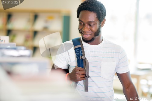 Image of Student Looking At Books In Bookstore