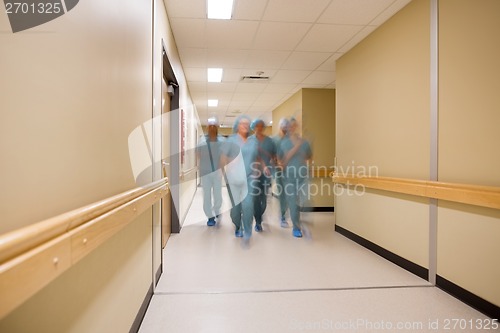 Image of Multiethnic Medical Team Walking In Hospital Corridor