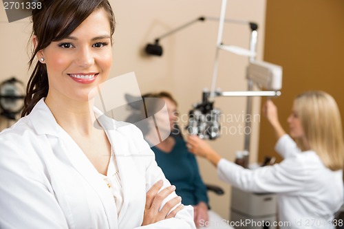 Image of Female Optometrist With Colleague Examining Patient