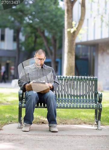 Image of University Student Using Digital Tablet On Campus