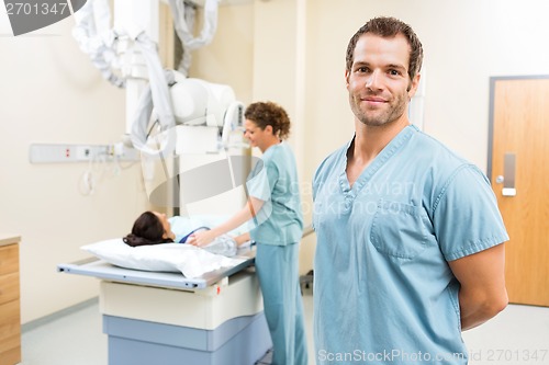 Image of Nurse With Colleague Preparing Patient For Xray