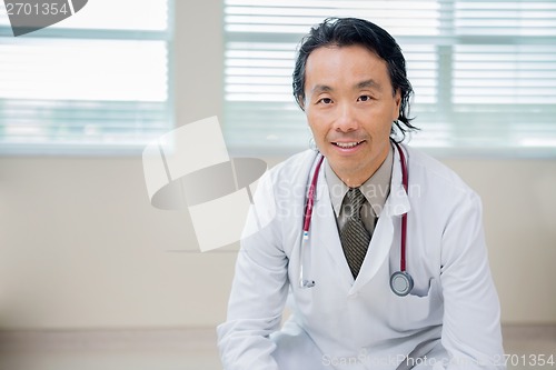 Image of Male Doctor Sitting In Hospital Room