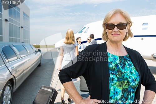 Image of Confident Businesswoman Against Private Jet