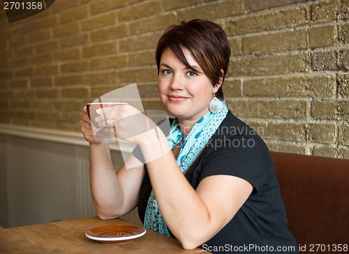 Image of Smiling Woman Holding Coffee Cup In Cafeteria