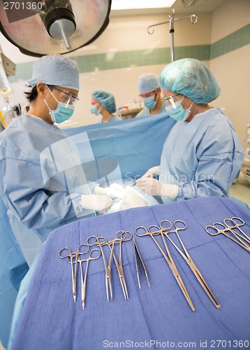 Image of Doctors Operating Patient In Operation Room