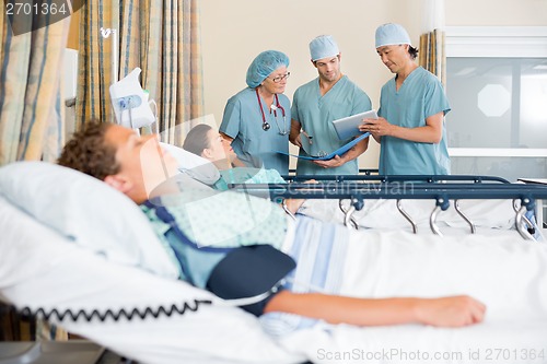 Image of Nurses Discussing Patient's Chart Post Surgery