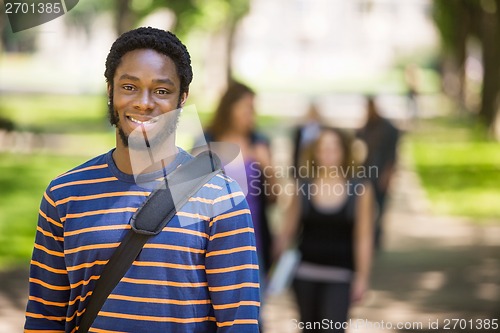 Image of Young Male Grad Student Smiling On Campus