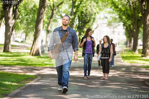 Image of Confident Male Grad Student Walking On Campus