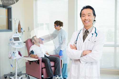 Image of Happy Doctor With Patient Being Examined By Heartbeat Machine