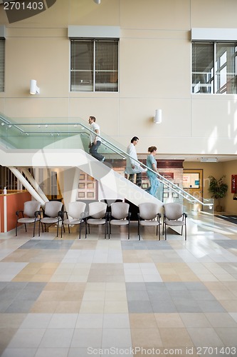 Image of Medical Team And Patient Walking On Stairs