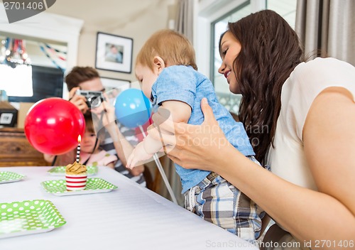 Image of Family Celebrating Son's Birthday At Home