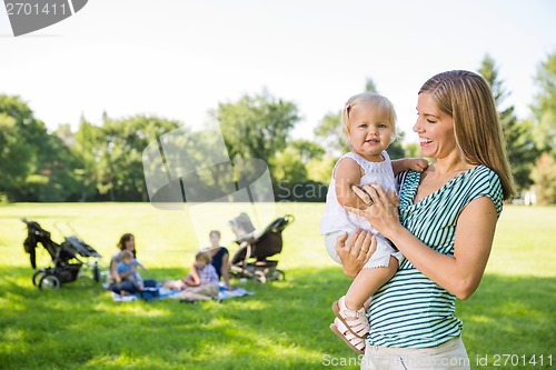 Image of Mother Looking At Cute Daughter In Park