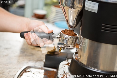 Image of Barista Holding Portafilter With Ground Coffee