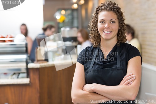 Image of Happy Owner Standing Arms Crossed In cafe