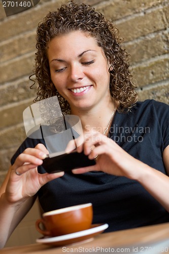 Image of Woman Photographing Coffee In Cafeteria