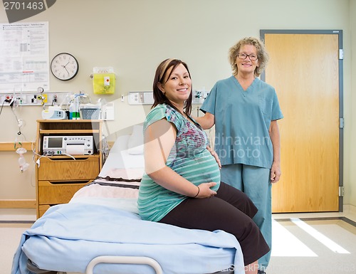Image of Happy Nurse And Pregnant Woman In Hospital Room