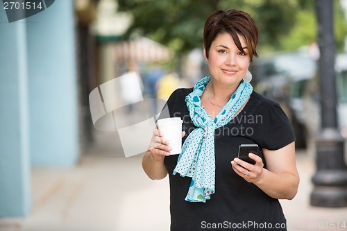 Image of Woman With Coffee Cup Messaging On Smartphone