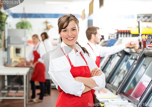 Image of Confident Female Butcher Standing Arms Crossed