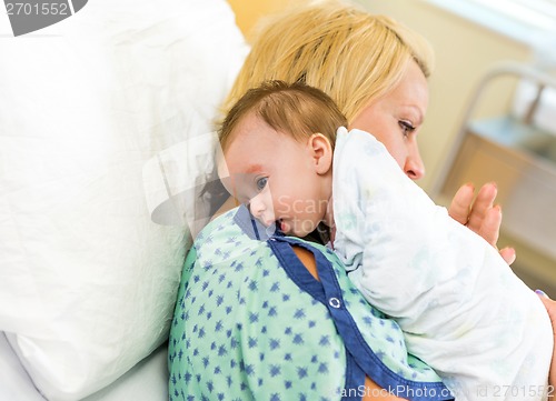 Image of Babygirl Resting On Mother's Shoulder In Hospital