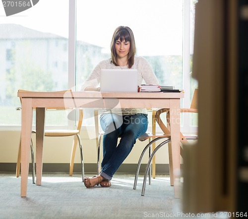 Image of Student Using Laptop In Library