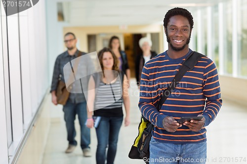 Image of Portrait Of Student Holding Digital Tablet On University Corrido