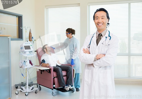 Image of Doctor With Patient Being Examined By Heartbeat Machine